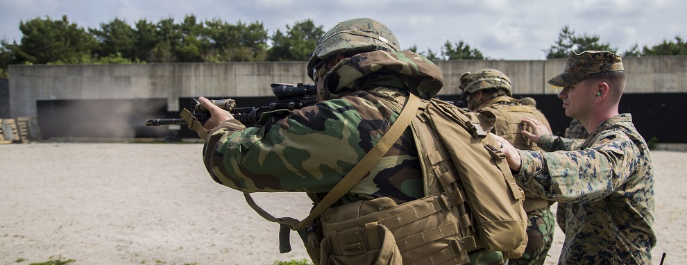 U.S. Marines with Headquarters Battalion, 3d Marine Division, engage the Table 5 course of fire in Mission Oriented Protective Posture gear Level 1 during III Marine Expeditionary Force Exercise (MEFEX) on Range 160, Camp Hansen, Okinawa, Japan, April 25, 2017. MEFEX serves as a simulated war exercise meant to strengthen the capabilities of the Marine Expeditionary Force and Division levels.