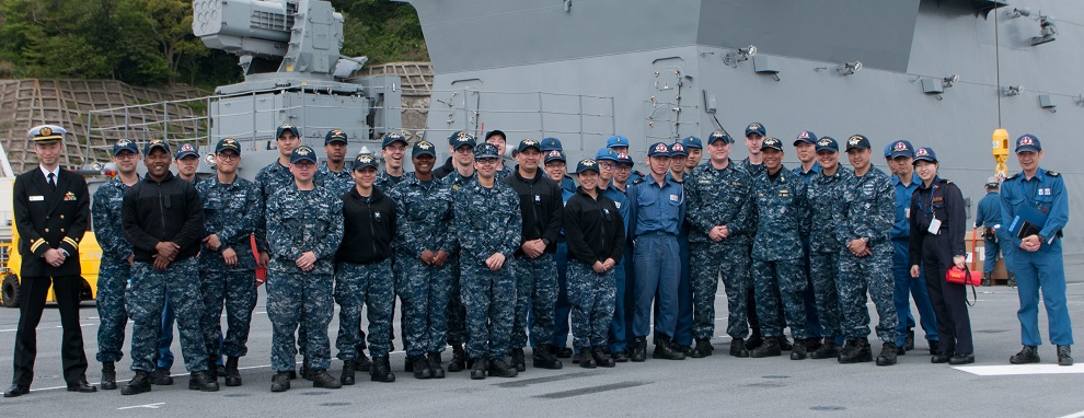 Sailors assigned to the Navy's only forward deployed aircraft carrier, USS Ronald Reagan (CVN 76), pose for a photo with Japanese Sailors assigned to JS Izumo (DDH 183) on Izumo's flight deck. Twenty Sailors from Ronald Reagan toured Izumo as part of a partnership event. Ronald Reagan, the flagship of Carrier Strike Group 5, provides a combat-ready force that protects and defends the collective maritime interests of its allies and partners in the Indo-Asia-Pacific region.