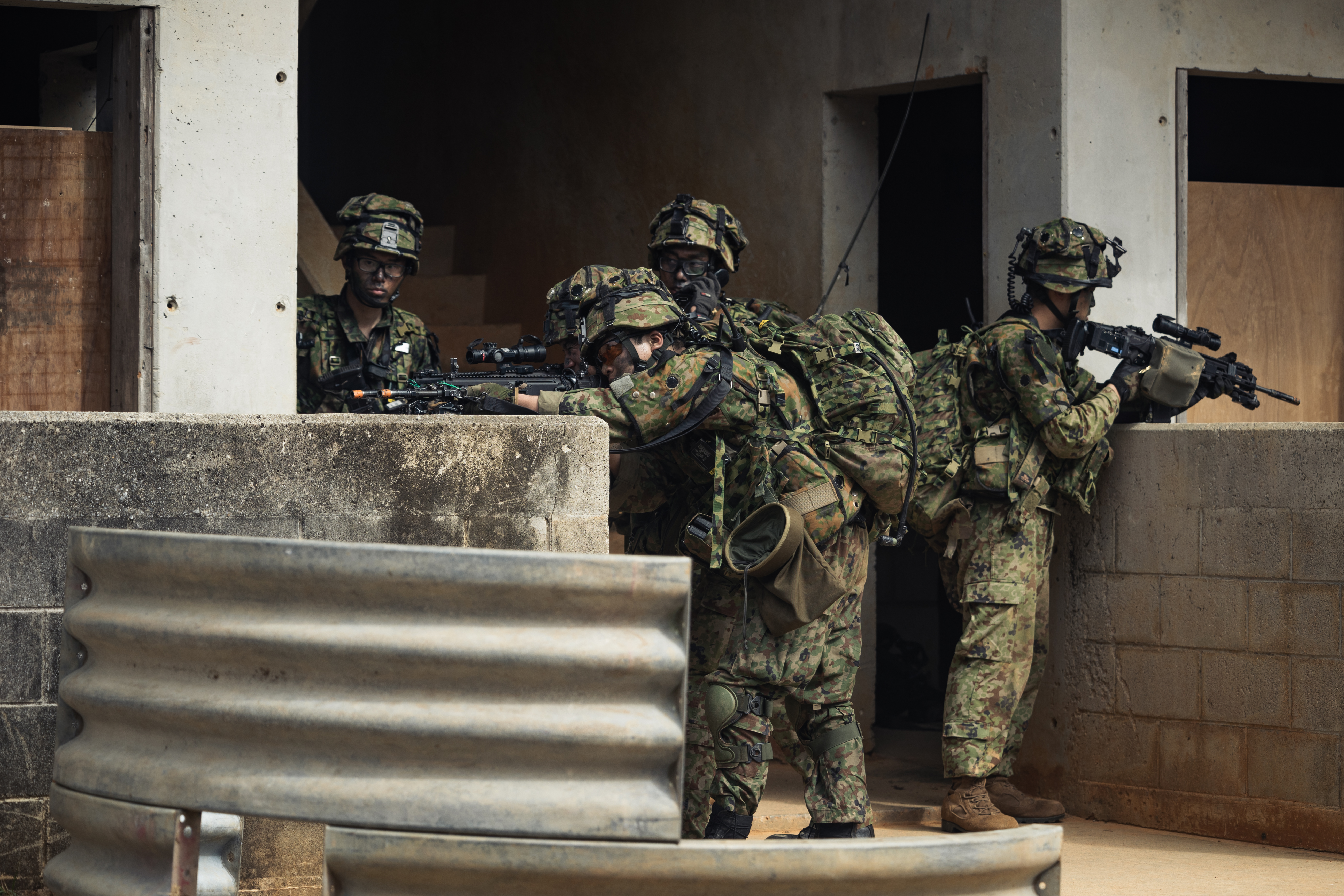 Japan Ground Self-Defense Force soldiers with the 1st Amphibious Rapid Deployment Regiment, set security during a simulated bilateral raid as part of Iron Fist 25 at Camp Hansen, Okinawa, Japan, March 3, 2025. 