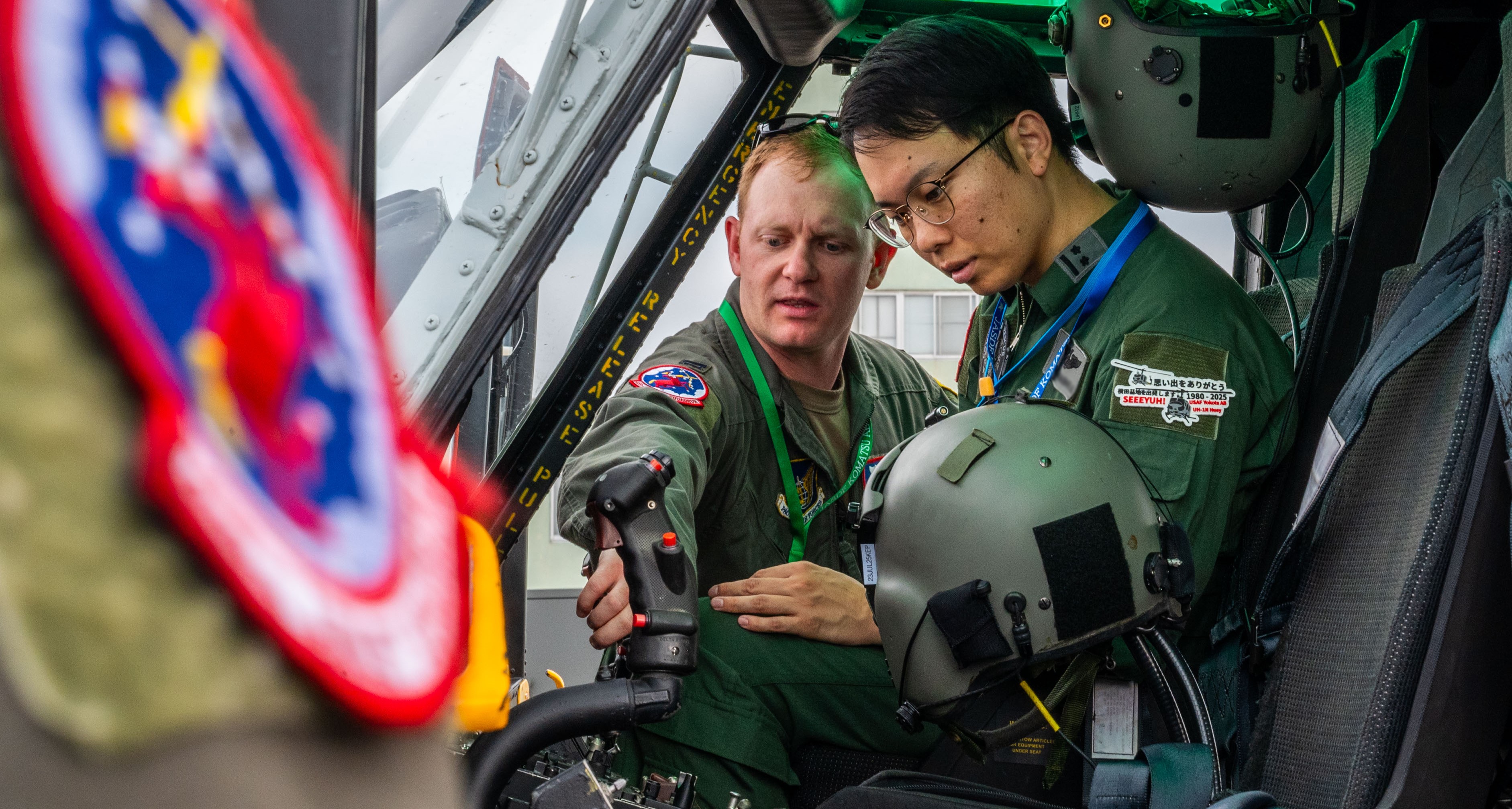 U.S. Air Force Capt. Colton McConnell, gives a tour of a UH-1N Huey to a Japanese Air Self-Defense Force Komatsu Air Rescue Squadron pilot during a bilateral exchange at Komatsu Air Base, Japan, June 27, 2025.