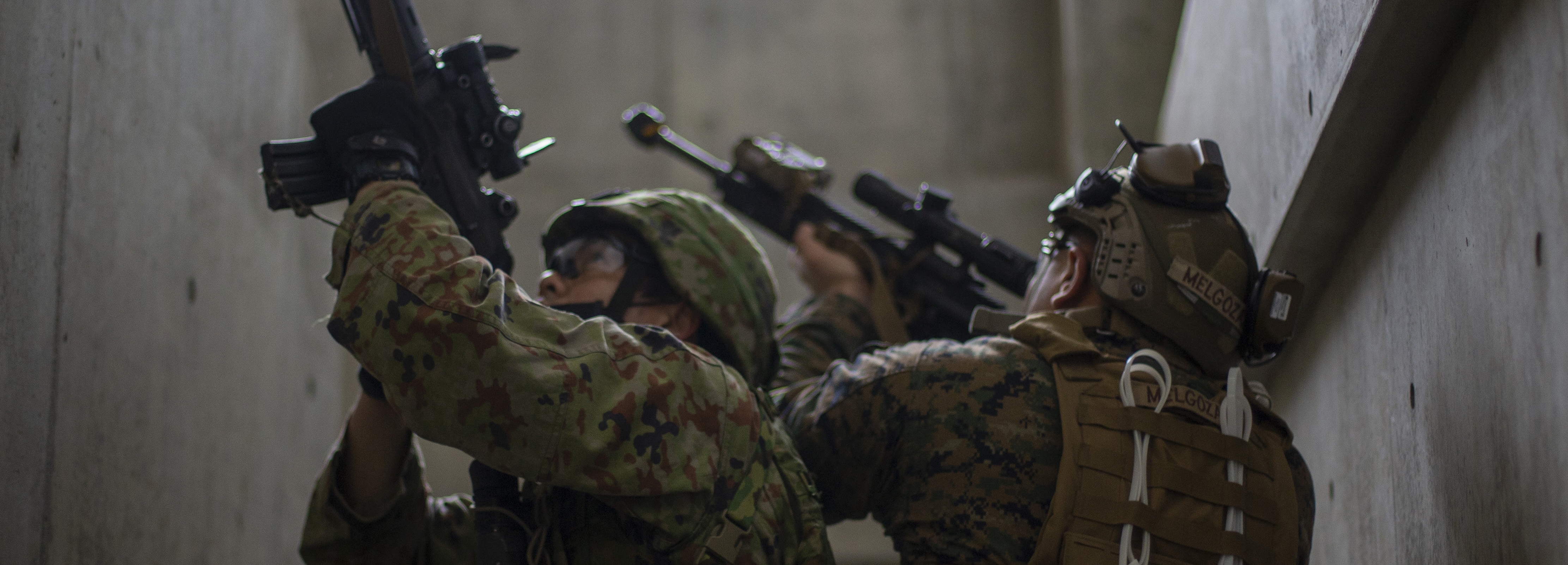 A U.S. Marine with Battalion Landing Team 1/5, 31st Marine Expeditionary Unit, and a Japanese soldier with the 1st Amphibious Rapid Deployment Regiment (1ARDR) work together to clear buildings during Military Operations in Urbanized Terrain (MOUT) training at Combined Arms Training Center Camp Fuji, Japan, March 16, 2022. MOUT training provides the organization, planning, and knowledge needed to be successful when conducting operations in an urban environment. Maritime Defense Exercise Amphibious Rapid Deployment Brigade is a bilateral exercise meant to increase interoperability and strengthen ties between U.S. and Japanese forces for the defense of Japan. (U.S. Marine Corps photo by Lance Cpl. Manuel Alvarado)