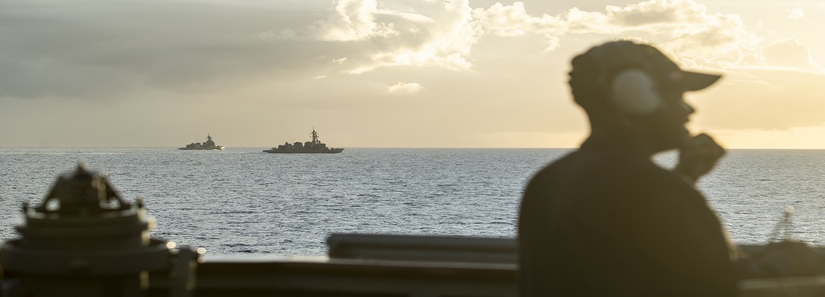 Navy Seaman Angelo Williams stands watch aboard the guided missile destroyer USS Curtis as it steams in formation with Japan Maritime Self-Defense Force destroyers JS Ariake and JS Asahi in the Philippine Sea, May 29, 2019.
